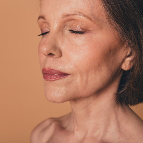 No filter close up photo of charming elderly woman face aging concept isolated on beige color background